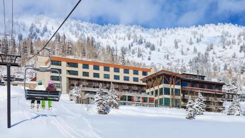 a ski lodge with two people on a ski lift at Alta's Rustler Lodge in Alta