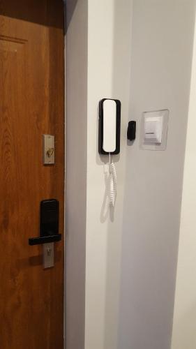 a phone on a wall next to a door at Na Rynku in Gliwice