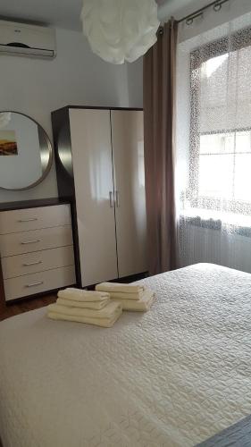 a bedroom with a bed with a dresser and a mirror at Na Rynku in Gliwice