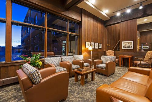a waiting room with couches and chairs and windows at Alta's Rustler Lodge in Alta