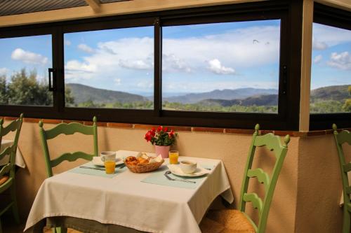 a table with a bowl of food and a basket of fruit at L'Estirado des Adrets in Les Adrets de l'Esterel