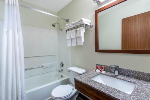 a bathroom with a sink and a toilet and a mirror at Super 8 by Wyndham Dubois in Dubois