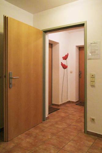 an empty hallway with red poppies on the wall at Apartments Bergblick in Sonnenalpe Nassfeld