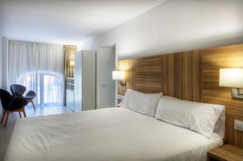 Uma cama ou camas num quarto em Apartaments Lauria