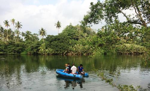 a group of people in a raft on a river at Villa The Leaf in Weligama