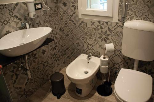 a bathroom with a white toilet and a sink at La boutique fronte fiera in Bologna