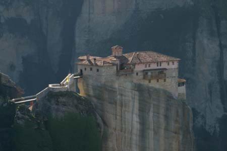 a painting of a castle on top of a cliff at Achillion Hotel in Tríkala