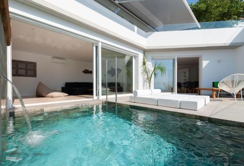 a house with a swimming pool and a living room at Vista Roses Mar - Cap Ponent in Roses