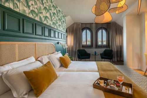a hotel room with a large bed with a tray on it at Puente Colgante Boutique Hotel in Portugalete