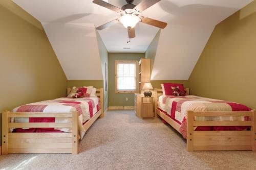two beds in a room with green walls at Tuckaway Retreat in Sylva