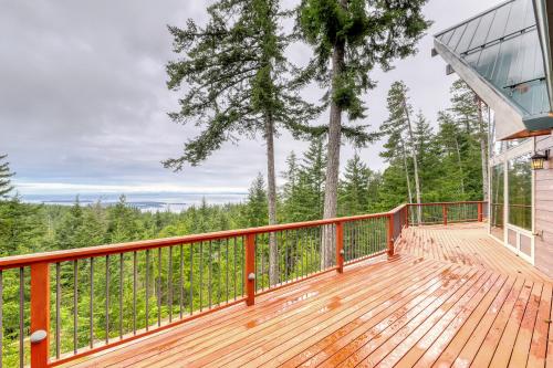 a large deck with a view of the woods at Sucia Island Mountain View in Eastsound