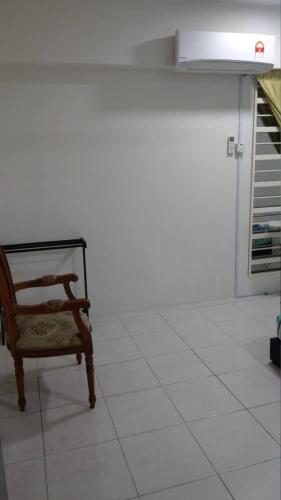 a chair sitting on a tiled floor in a room at Spacious & Cozy Condo - Hijauan Heights Block C in Kajang