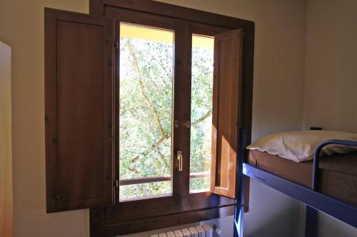 a bedroom with a window and a bunk bed at Alberg Roques Blanques in Ribes de Freser