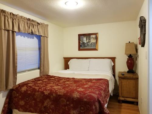 a bedroom with a bed and a window at Fig Cabin in Fredericksburg