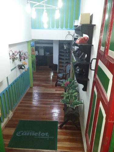 a hallway in a house with a door and a stairway at Hostel Camelot Salento in Salento