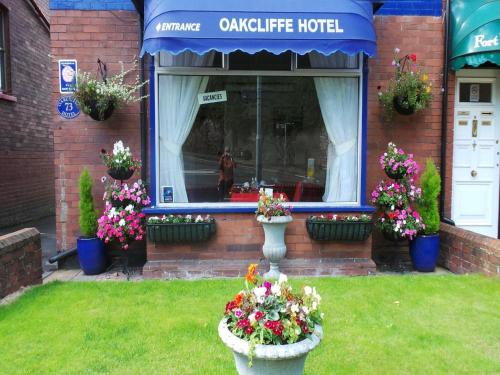a hotel with flowers in vases in the yard at The Oakcliffe in Exeter