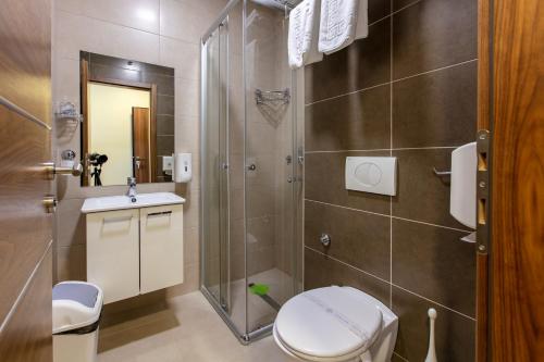 a bathroom with a toilet and a shower at Hotel IUT in Travnik