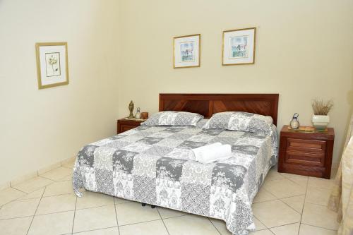 a bedroom with a bed and two night stands at Uyuca Vista Family Villa in Tegucigalpa