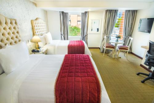 Postel nebo postele na pokoji v ubytování GHL Hotel Hamilton