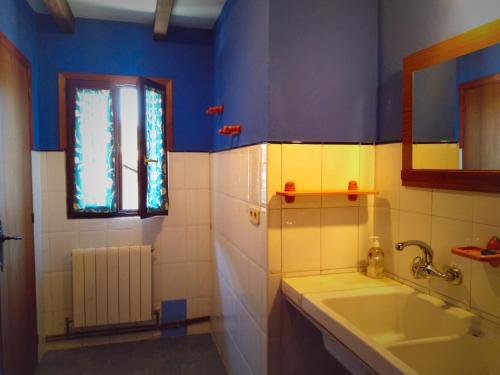 a bathroom with a sink and a window at Albergue Olasenea Aterpea in Zubieta