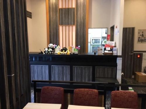 a room with a table and chairs and a counter at Ueno Urban Hotel in Tokyo