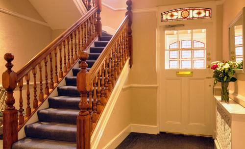 a stairway leading to a room with a large window at St Margaret's Hotel in Oxford