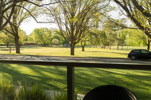 a view from a window of a park with a car at Forrest Hotel & Apartments in Canberra