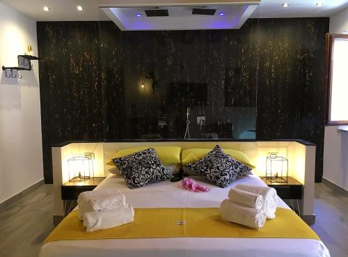 a bedroom with a large bed with two towels on it at Casa Busari in Palermo