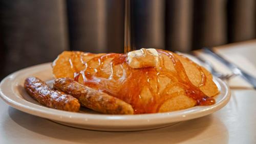 a turkey and sausage on a plate on a table at Best Western West Towne Suites in Madison