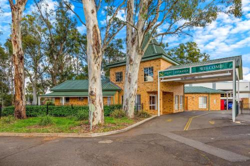 a gas station in front of a brick building at Quality Inn Penrith Sydney in Penrith