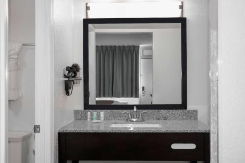 a bathroom with a sink and a mirror at Quality Inn Miami South in Kendall