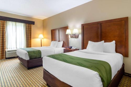 a hotel room with two beds and a window at Quality Inn & Suites Decatur - Atlanta East in Decatur