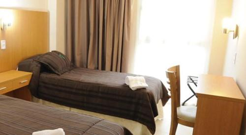 Postel nebo postele na pokoji v ubytování Hotel Osam