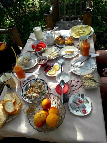 a table with many plates of food on it at Guest House Metreveli in Borjomi