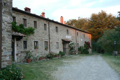 an old stone building with plants on it at Casina Della Burraia in Subbiano