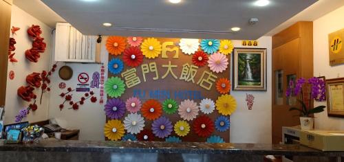 a wall in a kitchen with flowers on it at Fu Men Hotel in Pingtung City