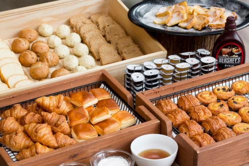 three wooden boxes filled with different types of pastries at Hotel Monterey Le Frere Osaka in Osaka
