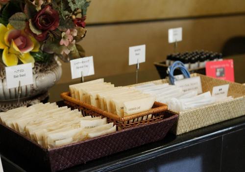 a display of cheeses in baskets on a table at Hotel Sorriso Hamamatsu in Hamamatsu