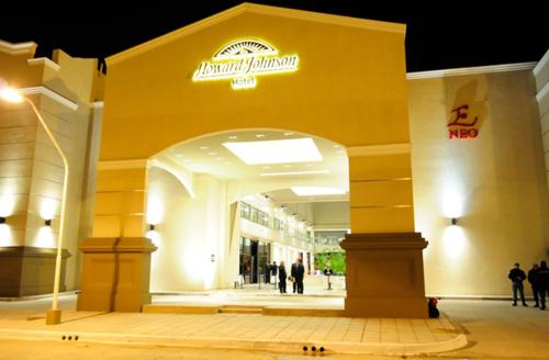 a shopping mall with people walking inside of it at night at Howard Johnson Hotel & Casino in Formosa