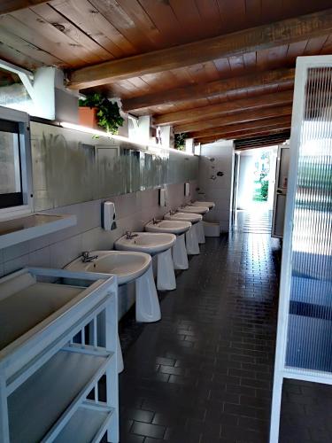 a row of sinks in a public bathroom at Camping Smeraldo in Trevignano Romano