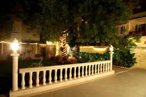 a white fence with lights in a yard at night at Khatu Haveli in Jaipur