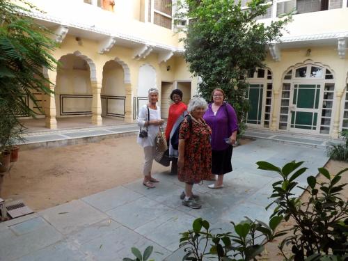 a group of women standing outside of a building at Khatu Haveli in Jaipur