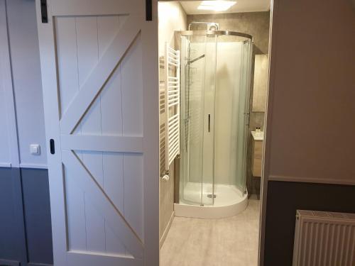 a bathroom with a shower and a glass door at Hotel,cafe,biljart POT in Groenlo