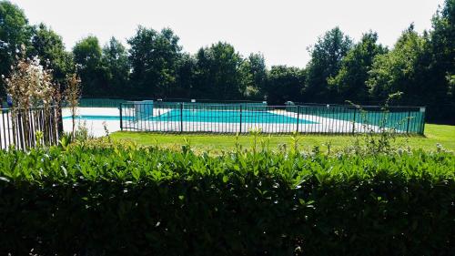 a swimming pool with a fence around it at Holiday Home Zeewolde in Zeewolde