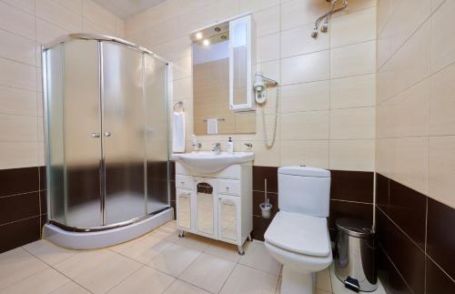 a bathroom with a shower and a toilet and a sink at Metelitsa Hotel in Krasnoyarsk