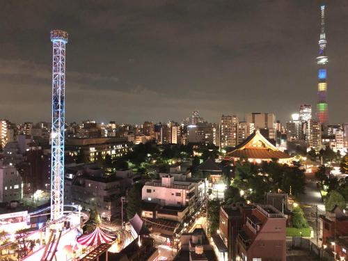 a city skyline at night with a tall tower at Onyado Nono Asakusa Natural Hot Spring in Tokyo