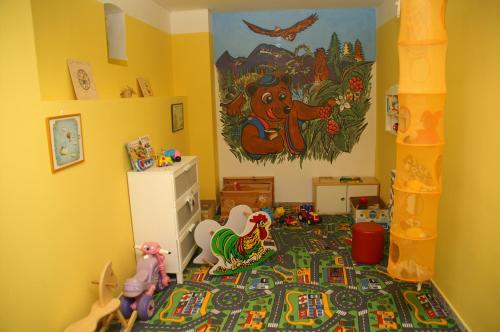 a childs room with toys on the floor at Hotel Avalanche in Štôla