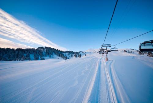 a ski lift on a snow covered ski slope at Hotel Cristal Flumserberg in Flumserberg