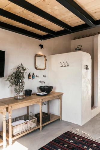a bathroom with a counter with a sink and a mirror at Casita Casita Lindos - Adults Only in Líndos