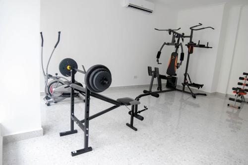 a gym with several exercise bikes in a room at Monarch Hotel in Accra